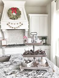 Red, grey and white christmas kitchen decor, a sleigh over the kitchen island, printed linens and a mini christmas tree. 2018 Christmas Decorating Ideas Home Bunch Interior Design Ideas
