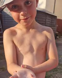 Rare pink grasshopper discovered under trampoline in back garden