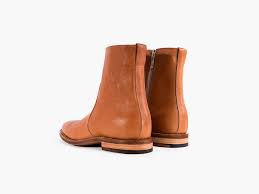 A solid hued midi dress featuring short sleeves, side pockets and side slits. Viberg Side Zip Camel Imboldn