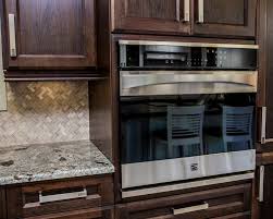Pendant lights hang from the ceiling and highlight the small island in the center of the kitchen. Kitchen Cabinets Dowdal Cabinets And Countertops North Bay On P1b