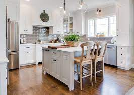 Dark colors provide dramatic contrast to the oak cabinetry. Kitchen Featuring Gray Backsplash White Oak Hardwood Floors And White Cabinets Farinelli Constru Oak Hardwood Flooring White Gloss Kitchen Dark Oak Cabinets