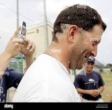 May 11, 2006; Delray Beach, FL, USA; American Heritage baseball coach Carm  Mazza has his hair cut by senior Rob Matthews, 18, after promising to do so  after his team advanced to