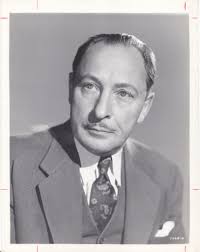 Portrait of Ted Bishop and his wife taken outside Turner Richards'  Photography Studio. Mr. Bishop is wearing his uniform in this February 1943  photograph. (Tacoma, WA)