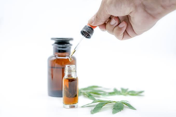High purity hemp extract vape liquid in clear glass bottle on timber background