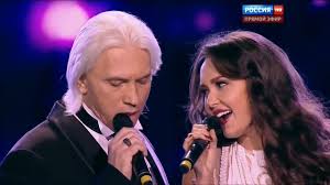 The stage lights dimmed, and in their place rose two voices that seemed  carved from memory itself — Dmitri Hvorostovsky's baritone, dark and velvet  with sorrow, and Aida Garifullina's soprano, shimmering like
