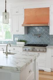 White And Blue Kitchen Features White Shaker Cabinets Paired With Pental Quartz Tobacco Countertops And Kitchen Tiles Backsplash Kitchen Tiles Kitchen Remodel