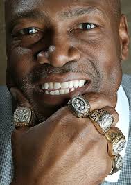This powerful image showcases the legendary Charles Haley, a man whose name  is synonymous with winning in the NFL. With five Super Bowl rings adorning  his hand, Haley holds the distinction of