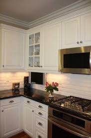 Backsplash For Black Countertops And White Cabinets Traditional Kitchen W White Cabinets White Subway Tile Black Countertops Dark Hardwood Fl Beveled Subway Tile White Kitchen Traditional Classic Backsplash