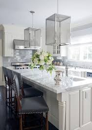 Traditional kitchen with gray cabinets and subway tile backsplash with white granite countertop and breakfast bar island. Ivory And Gray Kitchen With Gray Subway Backsplash Tiles Transitional Kitchen Pepino Home Decor Home Kitchens Kitchen Cabinets Decor White Kitchen Design