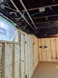 We just ripped up the subfloor in our kitchen as part of a remodel (the basement is below) and there is a crazy maze of ugly mechanicals running all through it. Painting An Exposed Basement Ceiling Black The Cozy Clarks