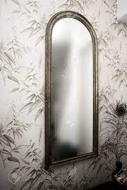 Originally when i first started my mirror business back in 2006 i thought that i would do all my finishes on. Long Vintage Mirror On Wall With Wallpaper And Peacock Feather Stock Photo Picture And Royalty Free Image Image 128204011