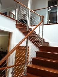 Custom manufactured spiral staircases in wood, metal, or metal and wood. Teak Stairway With Stainless Cables And Glass Panels Stairway Railing Ideas Stairways Brass Decor