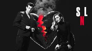 The promos for this week's upcoming controversial episode of saturday night live have arrived in the promo, musical guest miley cyrus flanks tesla founder and host elon musk on stage, wearing a red feathered ensemble with a black n95 mask, gold hoops, and exaggerated blue eye makeup. Miley Cyrus And Mark Ronson Saturday Night Live Promos December 2018 Hawtcelebs