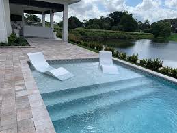 Aqua Chairs In Pool Chaise Loungers Arrive In Delray Beach Fl Year Round Enjoyment On Your Tann Pool Chaise Pools Backyard Inground Backyard Pool Landscaping