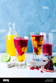 Dos Vasos De Bebidas Coctel Con Licor De Naranja El Zumo De Pina Y El Jugo De Granada Y Limon Y Hielo En La Tabla Fotografia De Stock Alamy