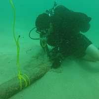 Hospital Corpsman 1st Class Virgil Newton, assigned to Underwater  Construction Team (UCT) 2, installs lifting points