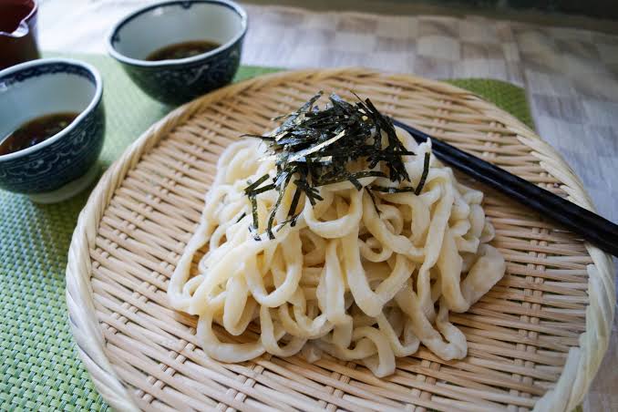 Fresh udon noodles being prepared
