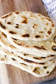 Naan Is A Traditional Indian Flat Bread That Is Pillowy Soft And Delicious This Easy Naan Bread Recipe Recipes With Naan Bread Plain Yogurt Recipes Naan Bread