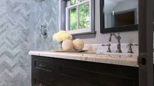 Gorgeous sophisticated bathroom design with black bathroom vanity, marble counter top, polished chrome hardware, black mirror, bench, frameless glass shower and sconces. Jeff Lewis Design Bathroom Youtube