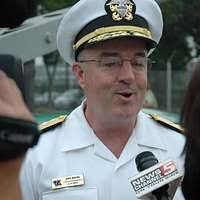 Chief of Naval Personnel, Vice Adm. John C. Harvey Jr., right,  congratulates Navy Reserve Medical Corps Captain Matthew Gratton, after  presenting a Bronze Star during Cleveland Navy Week opening ceremonies.