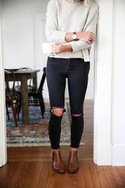 Chelsea boots are a classic ankle length boot for men and women. Free People Arctic Fox Sweater With Chelsea Boots And Black Distressed Skinny Jeans Fashion Chelsea Boots Outfit Distressed Skinny Jeans
