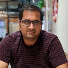 How do we calculate the minimum flow rate needed for circulating the fluid  in a continuous tubular reactor?