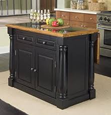 The island peninsula is accommodated by the enlarged cased opening to the living room, which has been painted a stark black to contrast against white walls. Amazon Com Monarch Black Distressed Oak Kitchen Island With Granite Top By Home Styles Kitchen Islands Carts