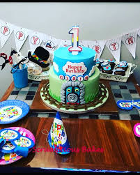 Ozair S First Bday Cake Thomas The Train Themed Cake Accompanied With Cupcakes And Mousse Scrumptious Bakes Cakegram Homeba Themed Cakes Cake Party Cakes