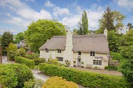 This Idyllic 16th Century Fairy Tale Thatched Cottage In Devon Is Up For Sale Devon Cottages Thatched Cottage Cottage Exterior