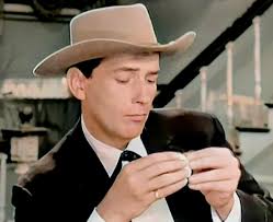 His voice sounded as if he had a mouth full of hot potatoes.