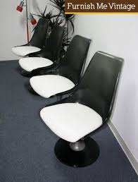 A few small marks in the lucite and bases. 4 Chromcraft Smoked Lucite And Aluminum Tulip Chairs