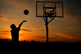Photo Silhouette of Teen Boy Shooting a Basketball at Sunset Image ...