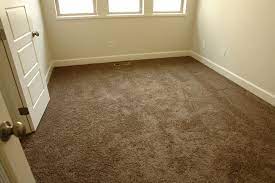 This living room features a beautiful dark wood floor, complemented by a white and gray rug in a moroccan pattern. This Dark Brown Carpet Really Helps Bring This Office Space Together With The Texture And Color It Provides Dark Brown Carpet Brown Carpet Bedroom Brown Carpet