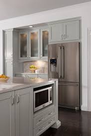 A muted green cabinet color adds depth and interest to the kitchen, while a butler sink and butcher block countertop adds a level of country chic. Mission Painted Stone Kitchen Cabinet Styles Kitchen Decor Apartment Painting Kitchen Cabinets