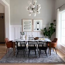 Wooden dining table with cushioned chairs, candle stands, frayed accessories, and flower vases all can bring a vintage charm to your dining room. Get The Look Chic Mid Century Modern Dining Room Posh Pennies