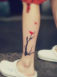 Birds Flying Away Tattoo Designs A Tattoo Design Featuring A Red Bird Resting On A Black Tree And Another Bird Flying Away Red Bird Tattoos Trendy Tattoos Calf Tattoo
