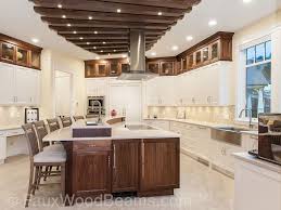 Wood ceiling beams, cool gray cabinets and stone floors. Stunning Kitchen Ceiling Treatment Faux Wood Workshop