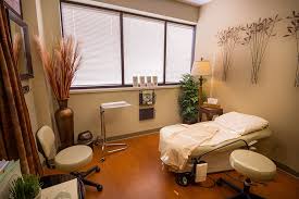 Calming women's wellness exam room with examination table and natural light