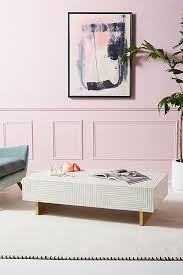This table's forged brass frame lends warmth to tiered slabs of acacia and marble. Savi Striped Inlay Coffee Table Anthropologie