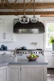 black dome range hood over wolf stove