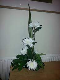 Line Arrangement Using Chrysanthemums Phormium And Fatsia Leaves Church Flowers Flower Arrangements Flowers