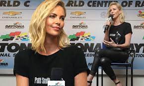 Medical staff wearing protective suits ride down an escalator at moscow's sheremetyevo international. Charlize Theron Rocks Skintight Leather Pants At Nascar Daily Mail Online