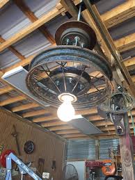 Vintage Wheel Converted To An Overhead Light Fixture Industrial Decor Project Idea Industrial Interior D Automotive Decor Garage Lighting Car Part Furniture