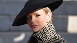 Princess Charlene is a gothic vision in lace veil for poignant outing