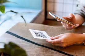 Visitor scanning QR code at memorial