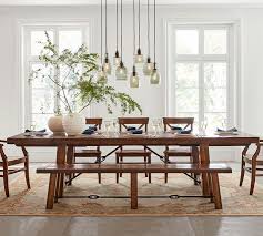 An expanding circular dining table in brown oak burr, with a base made from brown oak. The 8 Best Farmhouse Dining Tables Of 2021