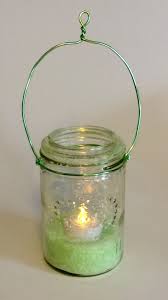 One mason jar candle holder provides a soft, warm glow while a group of them can be hung outdoors from hooks or tree branches to provide light and decoration for an outdoor party. Summer Essentials Hanging Mason Jar Candle Holder Make
