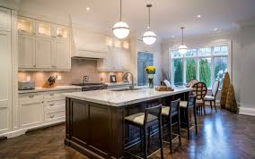 The dark finish on the table makes an excellent partner with the floors and walls. 34 Kitchens With Dark Wood Floors Pictures Dark Kitchen Floors White Kitchen Dark Floors Kitchen Flooring