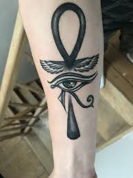 Many opt for wings that are akin to a phoenix. Eye Of Horus And Ankh Tattoo