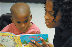 ... also a student at Stranahan High, reads to first grader Rayon James. - 06homegrown